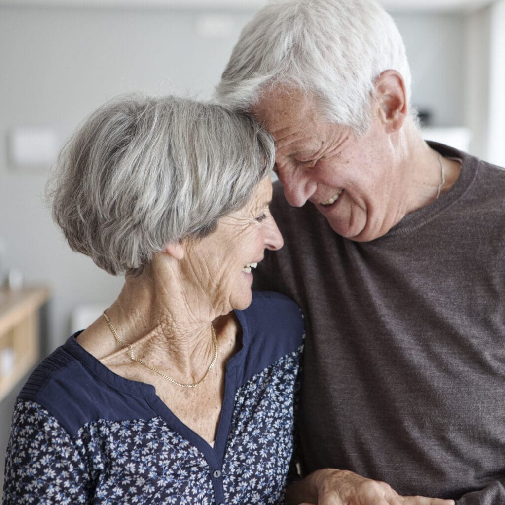 Senior couple with tablet at home aging in place